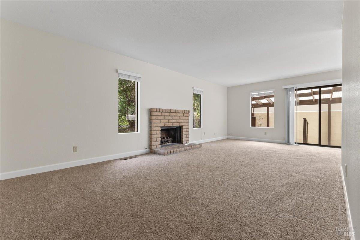 920 Shady Oak Drive Santa Rosa, CA 95404 - Photo 6 of 37 an empty room with windows and fireplace