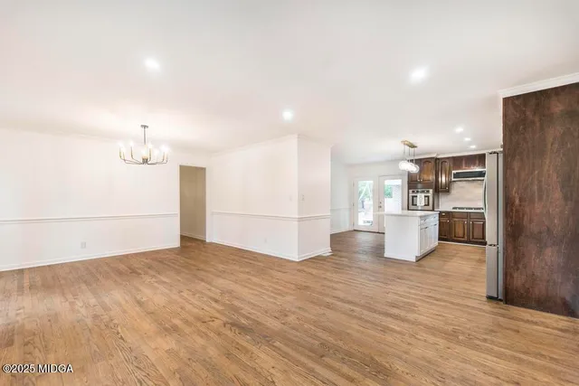 a view of a field with trees in the background