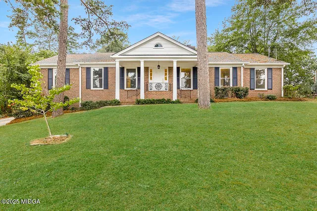 a front view of a house with a yard