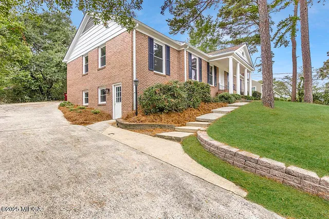 a view of a dining room with furniture a chandelier and wooden floor
