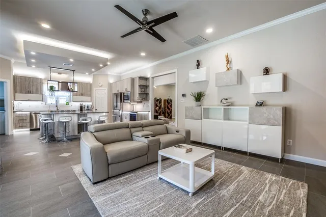 a living room with furniture and kitchen view