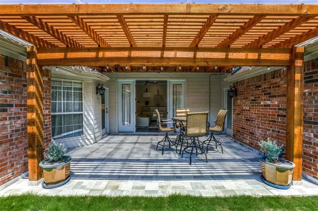 a view of a patio with table and chairs and potted plants