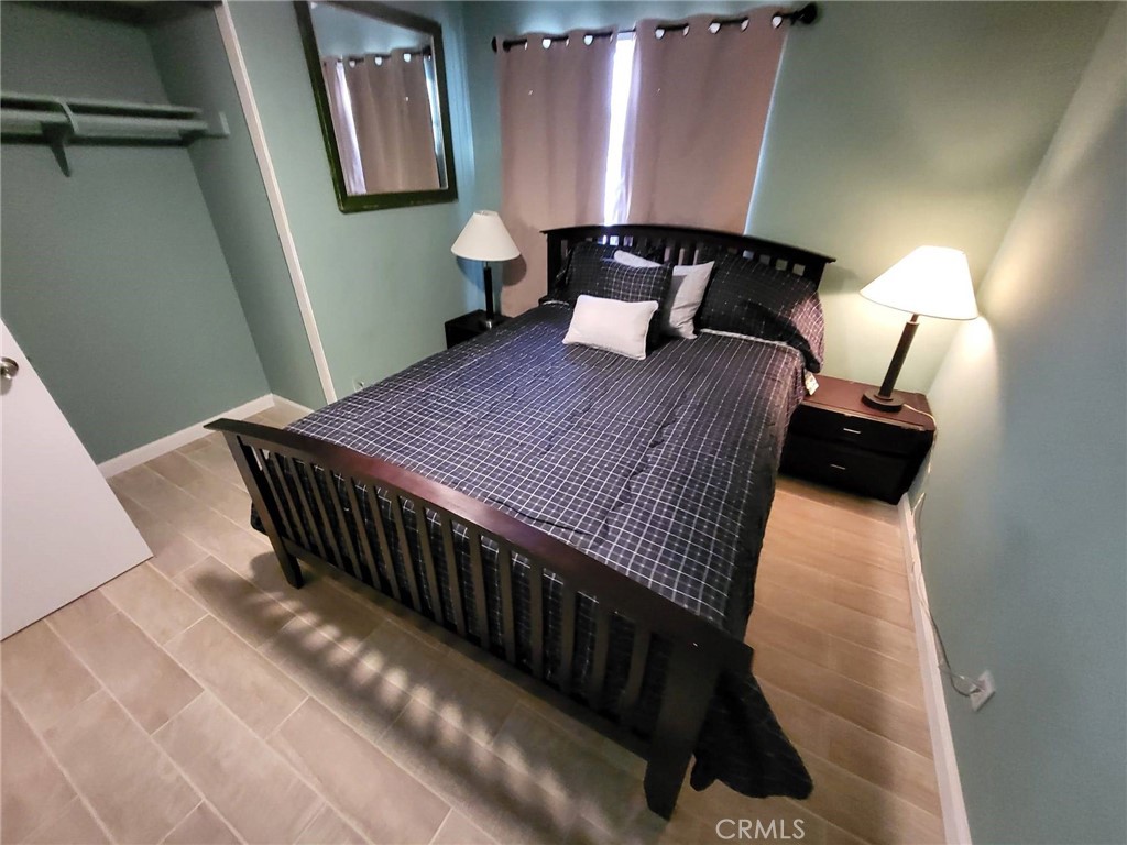 44025 Glenraven Road Lancaster, CA 93535 - Photo 3 of 5 a bedroom with a bed and window