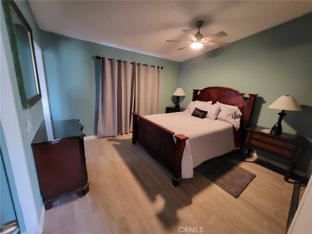 44025 Glenraven Road Lancaster, CA 93535 - Photo 4 of 5 a bedroom with a bed lamp and a fireplace