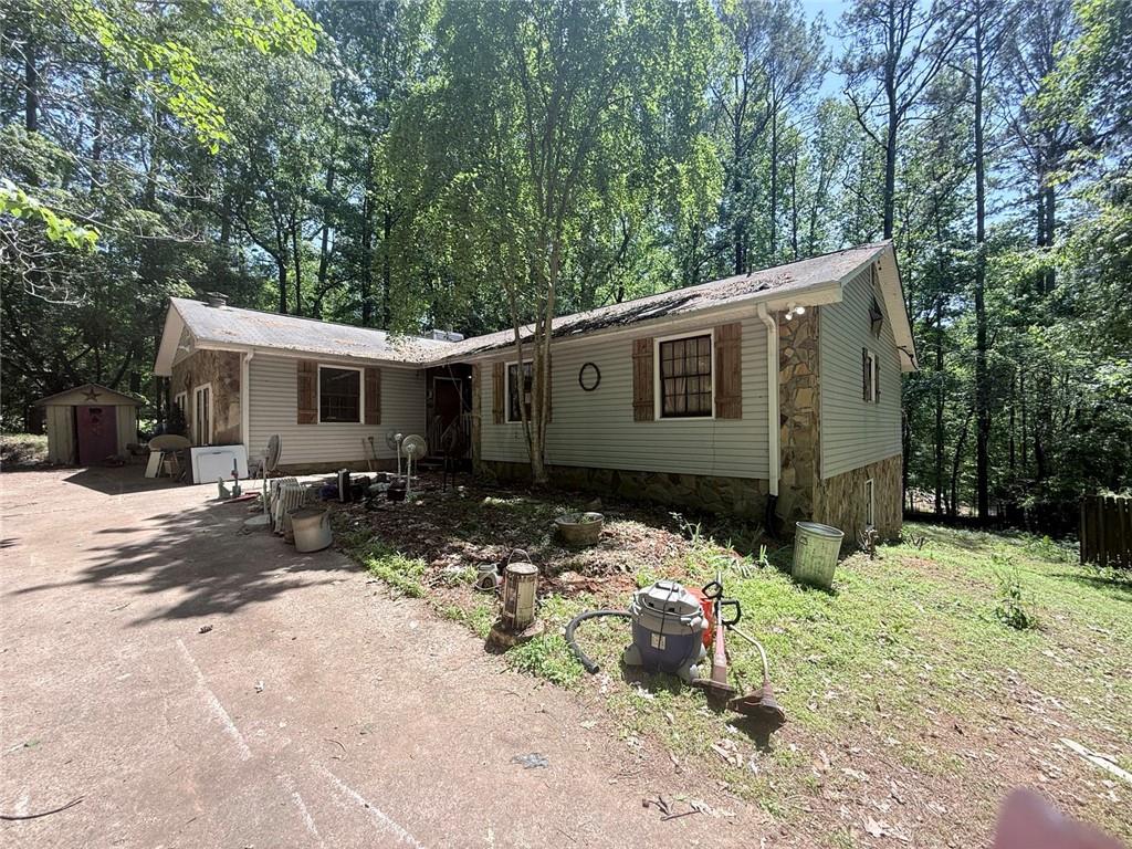 4564 Jade Trail Canton, GA 30115 - Photo 1 of 1 a view of a house with yard and covered with trees