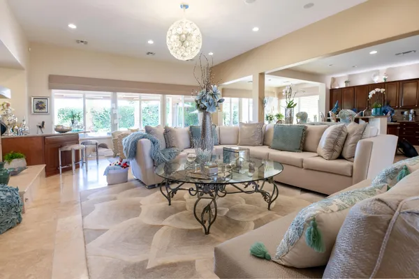 a view of a livingroom with furniture and a chandelier