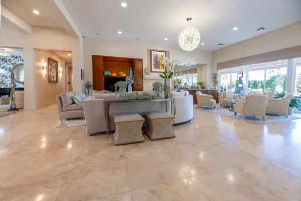 a bedroom with furniture and a large window