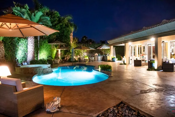 a view of a patio with chairs and a table