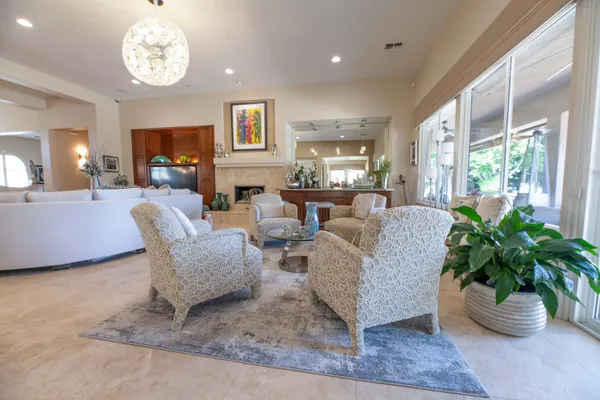 a view of a hallway to a livingroom with furniture