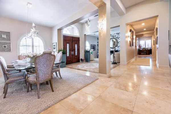 a living room with furniture and a mirror