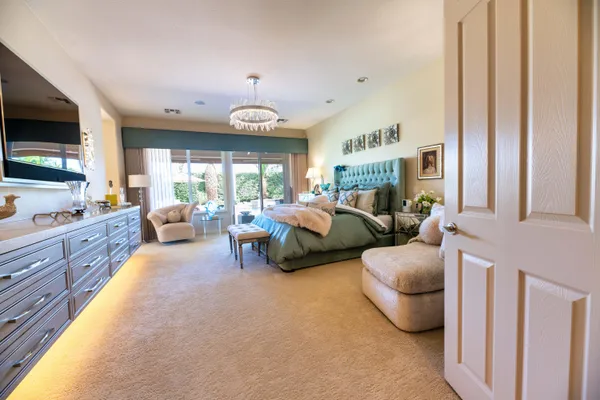 a kitchen with stainless steel appliances kitchen island granite countertop a dining table chairs and a refrigerator