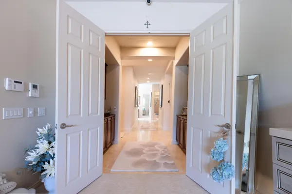 a bedroom with a bed and a chandelier