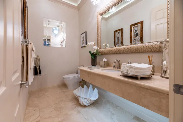 a view of a hallway with wooden floor and a living room