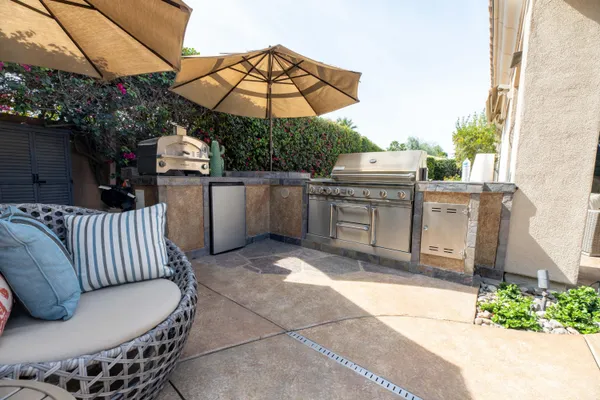 a view of a garden with a house in the background