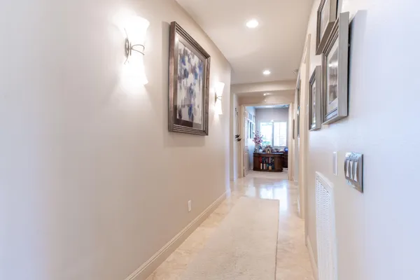 a view of a house with a yard and potted plants