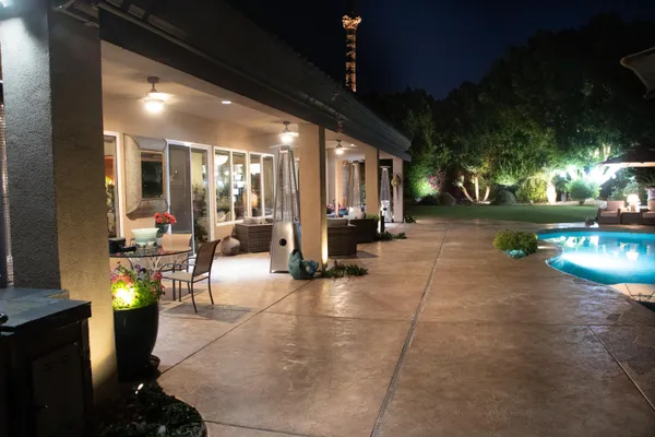 a view of swimming pool outdoor seating and yard