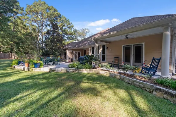 a view of a house with a yard patio and swimming pool