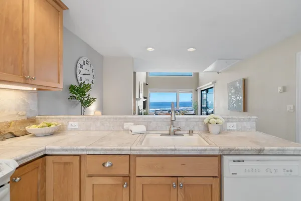 a kitchen with a refrigerator sink and cabinets