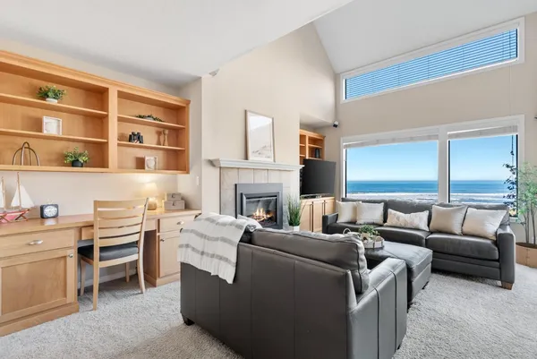 a living room with furniture a fireplace and a bookshelf
