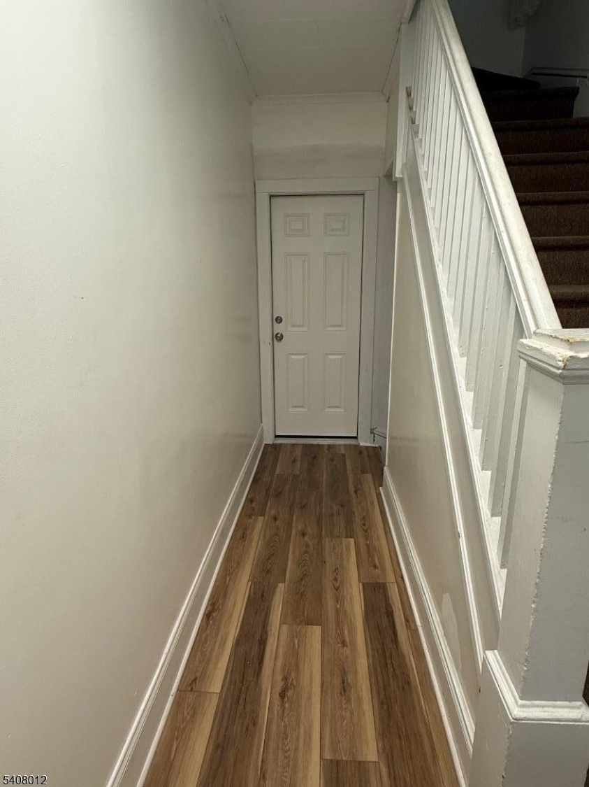 46 High Street, Unit 1 Clifton, NJ 07014 - Photo 11 of 14 a view of a hallway with wooden floor and stairs
