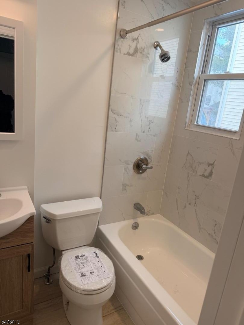 46 High Street, Unit 1 Clifton, NJ 07014 - Photo 6 of 14 a white toilet sitting next to a bath tub