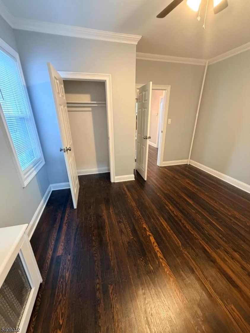 46 High Street, Unit 1 Clifton, NJ 07014 - Photo 8 of 14 a view of an empty room with wooden floor and a window