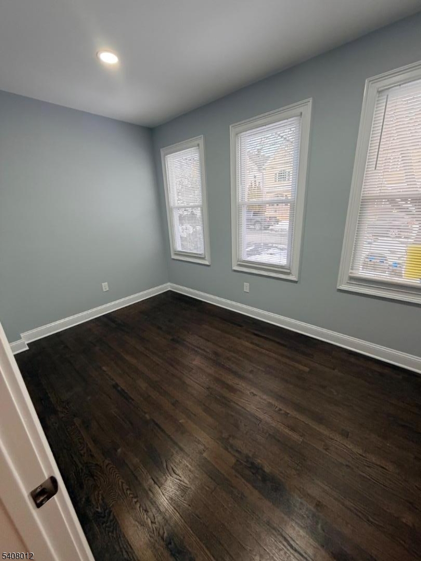46 High Street, Unit 1 Clifton, NJ 07014 - Photo 9 of 14 an empty room with wooden floor and windows