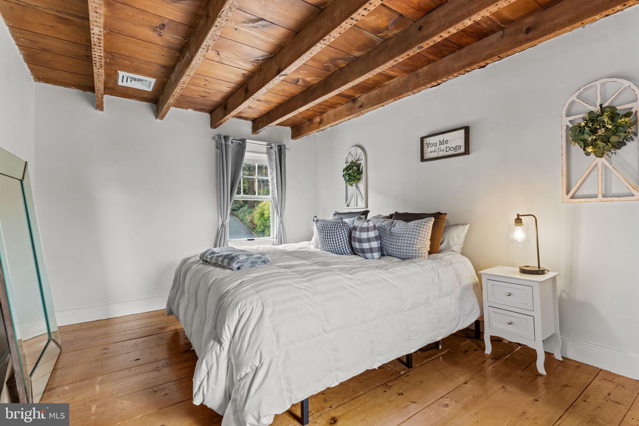 2565 Bogarts Tavern Road Doylestown, PA 18902 - Photo 12 of 31 a bedroom with a bed a potted plant and a dresser
