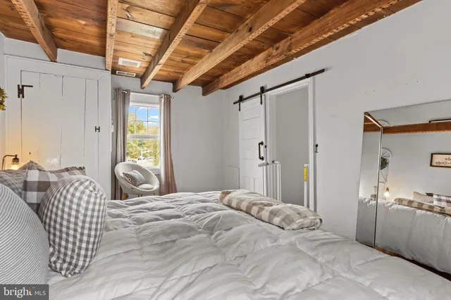 a bedroom with furniture and a large window