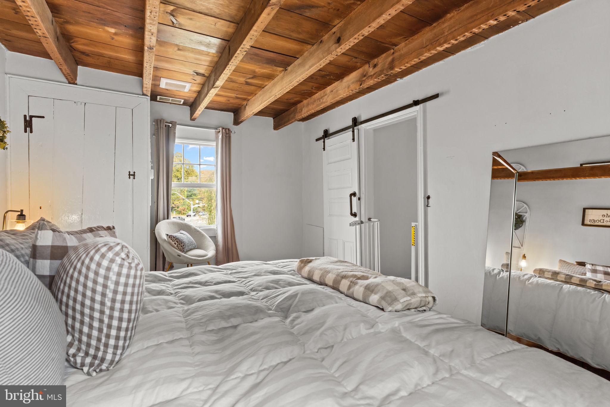2565 Bogarts Tavern Road Doylestown, PA 18902 - Photo 13 of 31 a bedroom with furniture and a large window