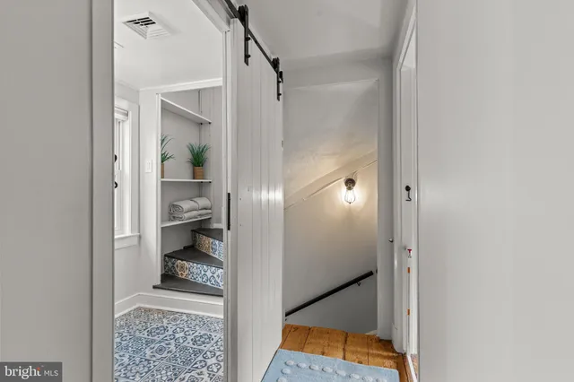 a bathroom with a glass shower door and a sink