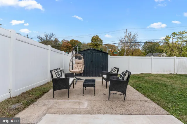 a view of a patio with table and chairs and potted plants