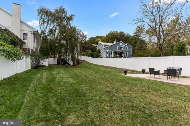 a view of a house with a yard and sitting area