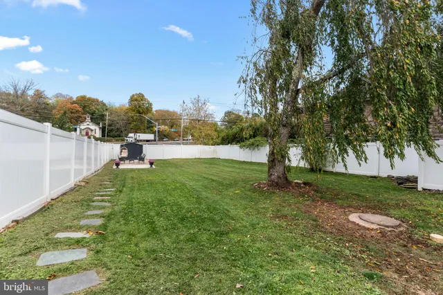 a view of a house with a yard and sitting area