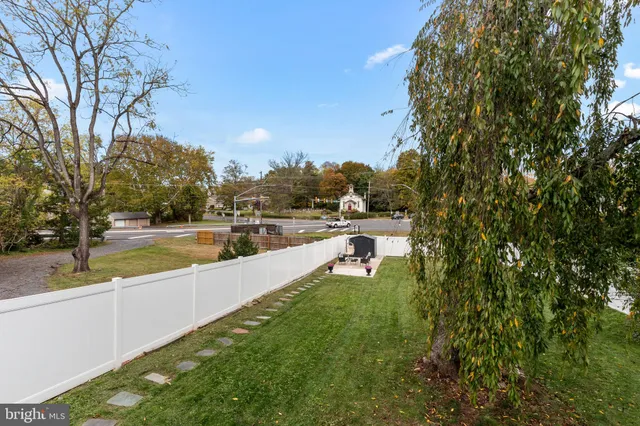 a view of a house with chairs and potted plants