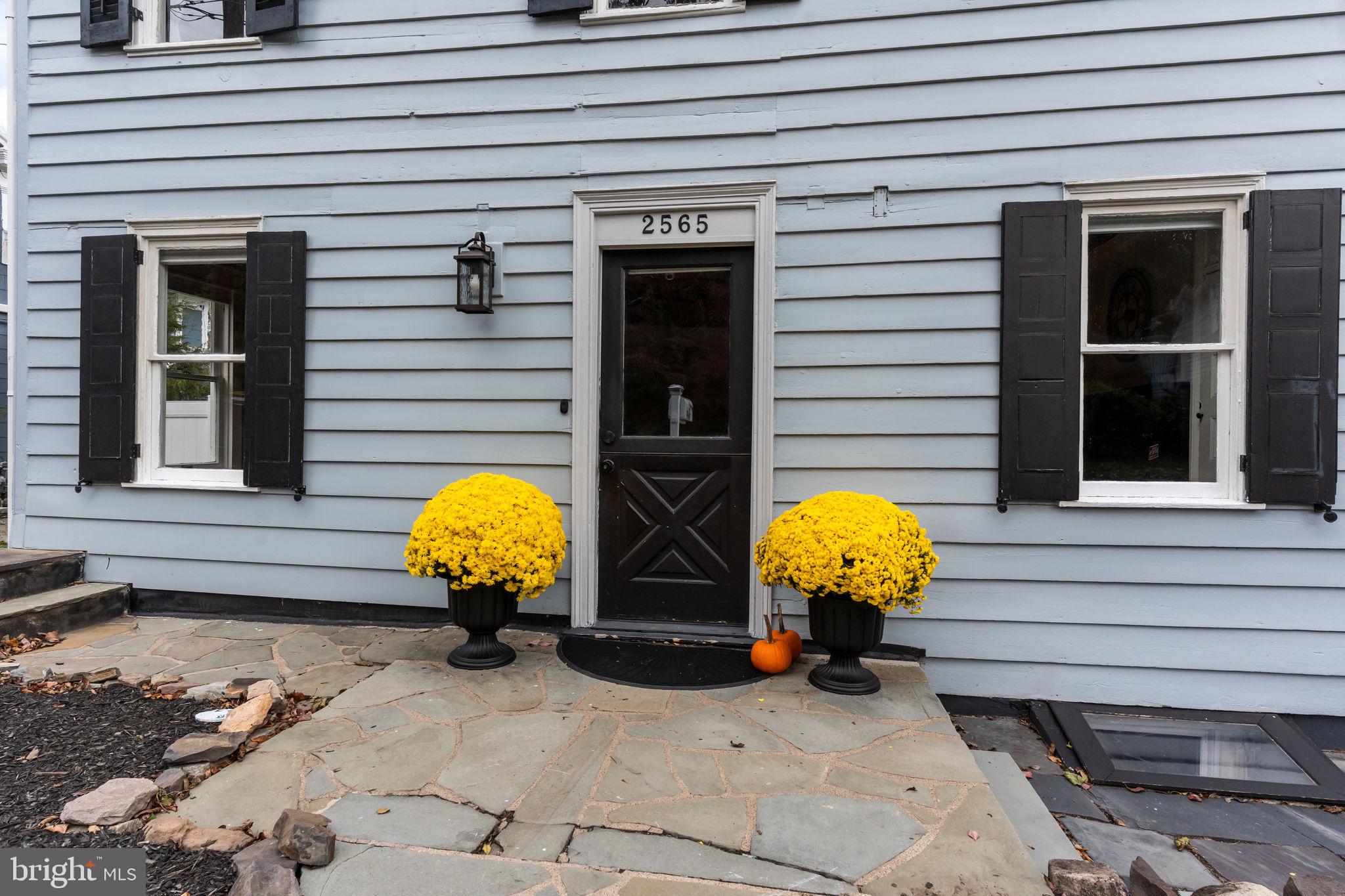 2565 Bogarts Tavern Road Doylestown, PA 18902 - Photo 30 of 31 a view of a house with chairs and potted plants