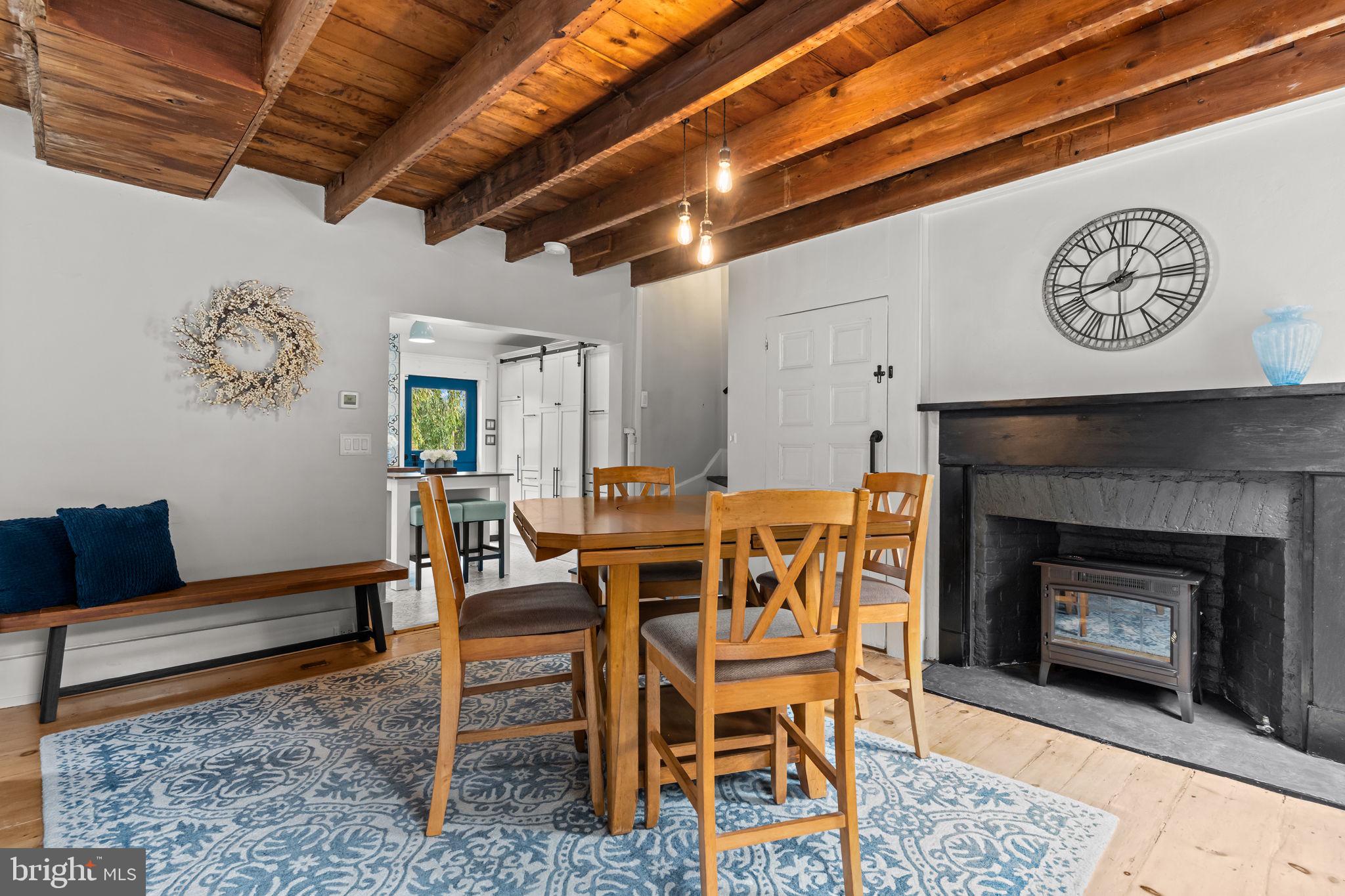 2565 Bogarts Tavern Road Doylestown, PA 18902 - Photo 8 of 31 a dining room with furniture and a fireplace