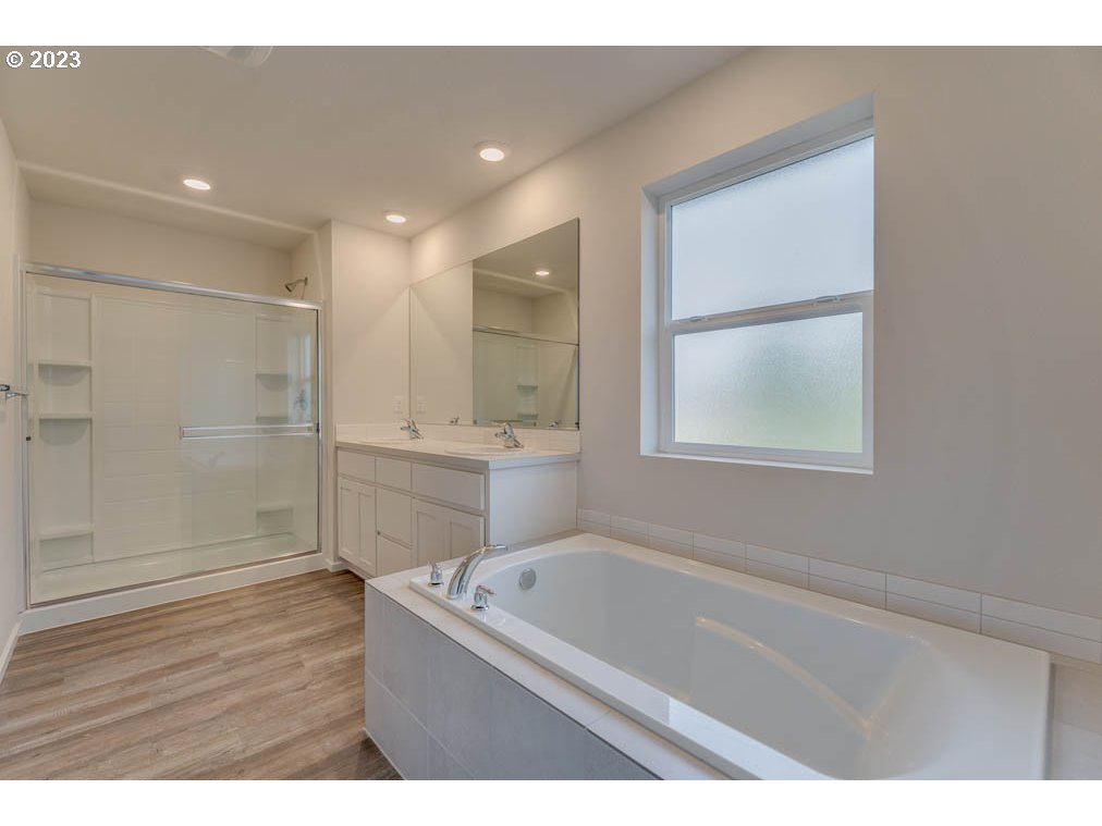 2642 26th Loop Springfield, OR 97477 - Photo 21 of 23 a bathroom with a tub a sink and a shower
