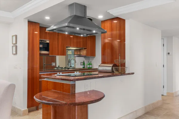 a kitchen with stainless steel appliances granite countertop a sink a stove and a refrigerator