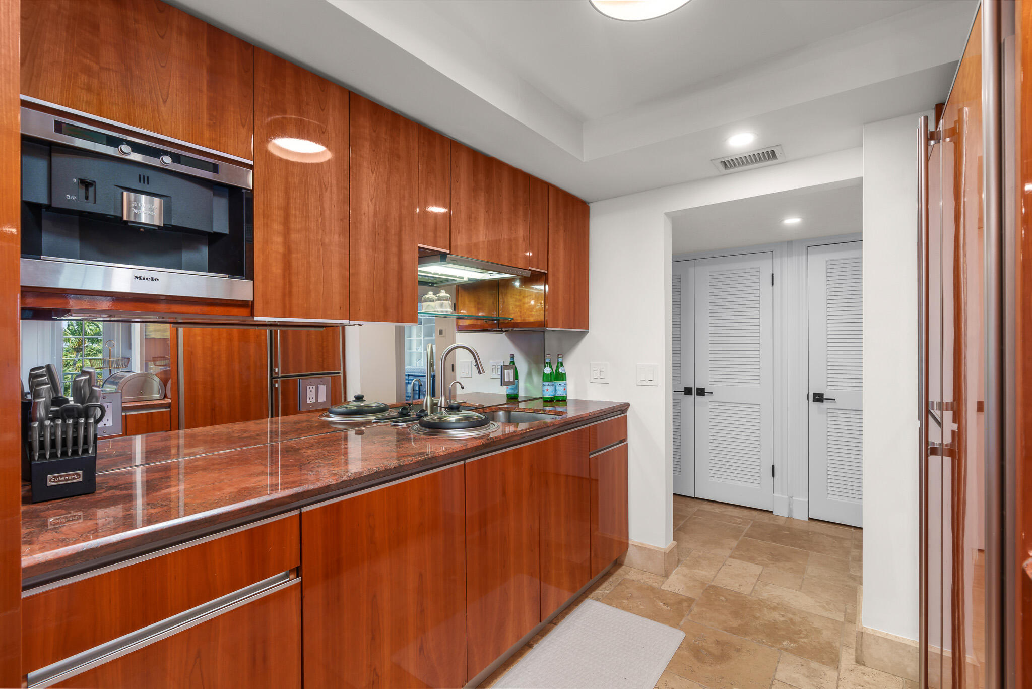 1111 South Ocean Boulevard, Unit 417 Boca Raton, FL 33432 - Photo 14 of 47 a kitchen with stainless steel appliances granite countertop a sink and cabinets