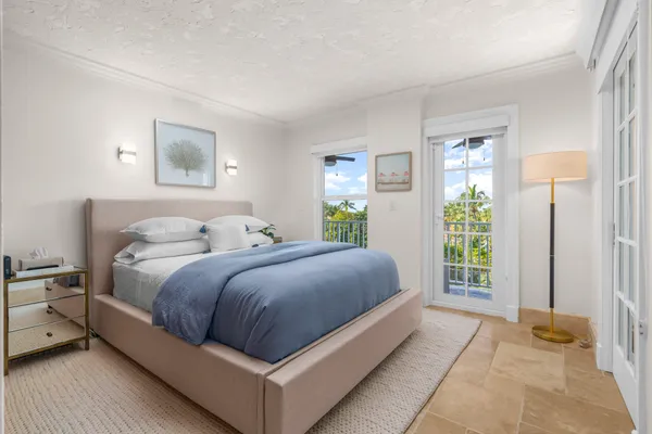 a spacious bedroom with a bed and a couch