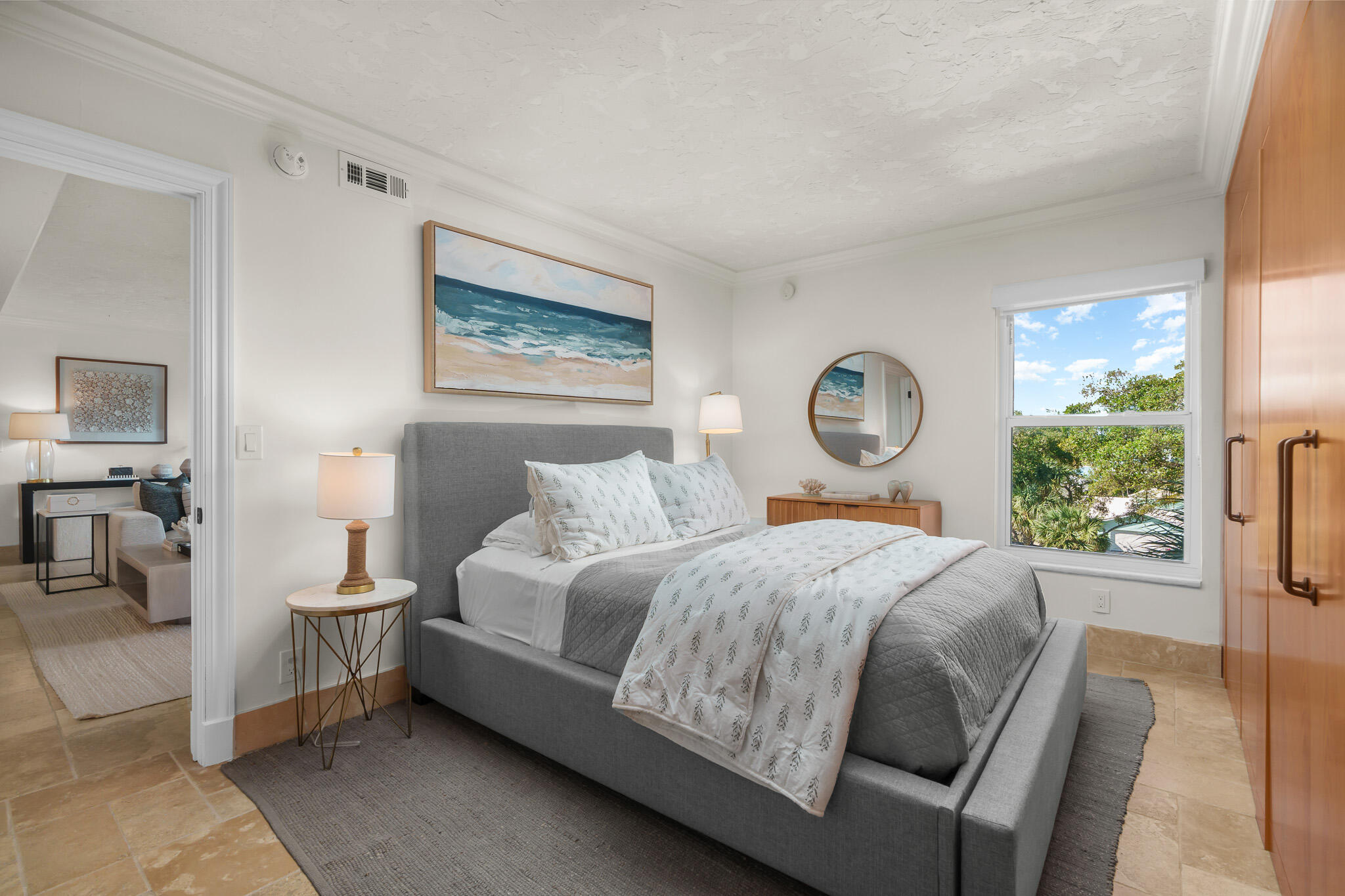 1111 South Ocean Boulevard, Unit 417 Boca Raton, FL 33432 - Photo 32 of 47 a bedroom with a bed a mirror and a window
