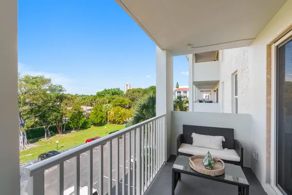 a view of a balcony with couches and wooden floor