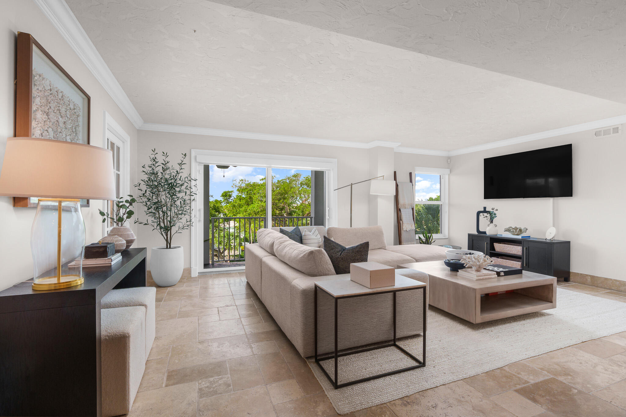 1111 South Ocean Boulevard, Unit 417 Boca Raton, FL 33432 - Photo 5 of 47 a living room with furniture and a flat screen tv