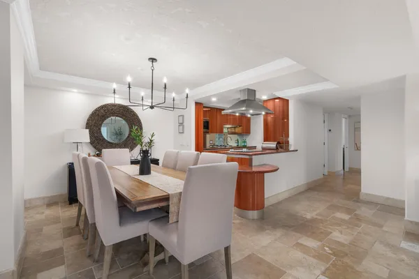 a view of a dining room with furniture and chandelier