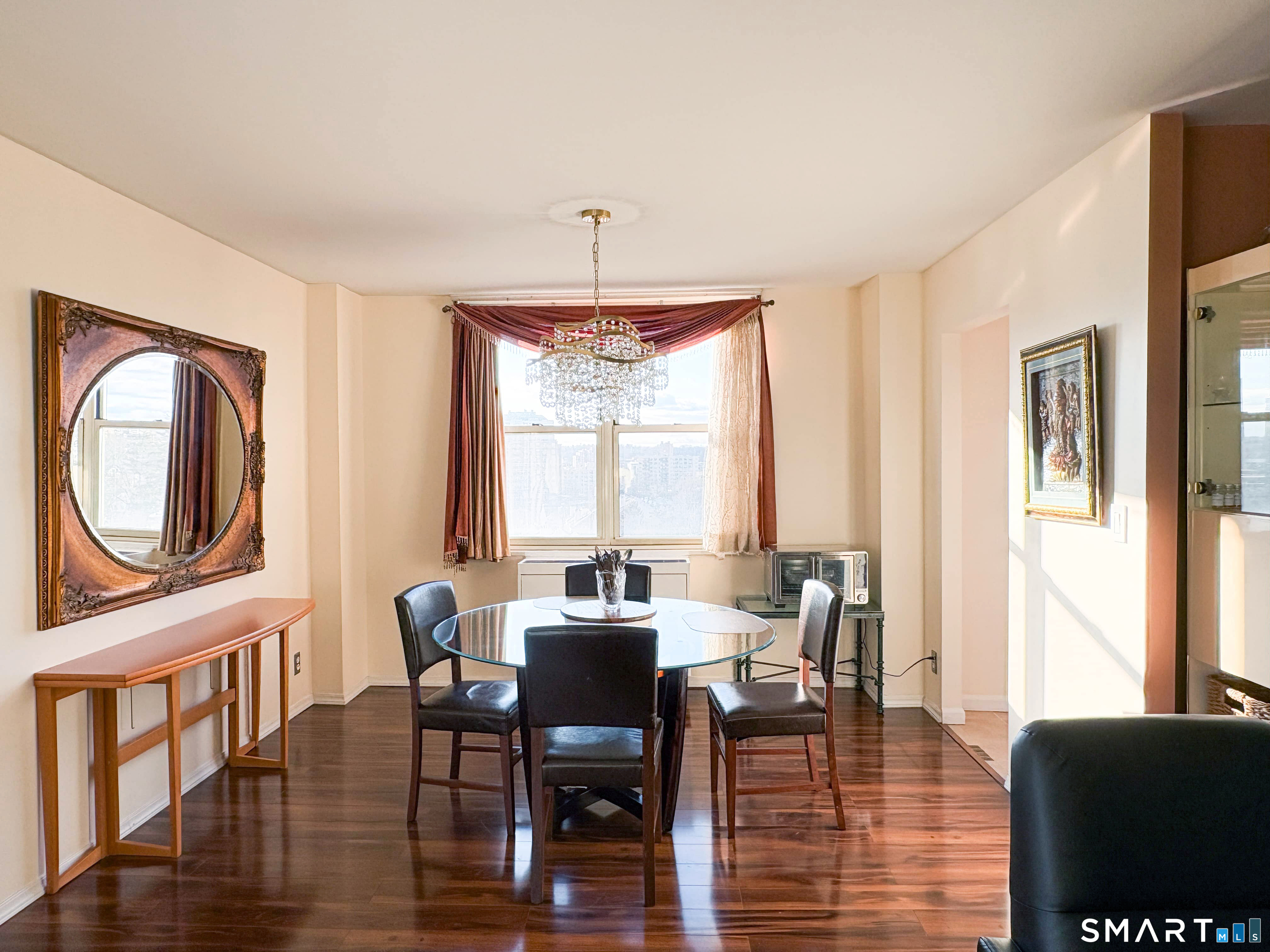 50 Glenbrook Road, Unit 9C Stamford, CT 06902 - Photo 2 of 20 a view of a dining room with furniture window and wooden floor