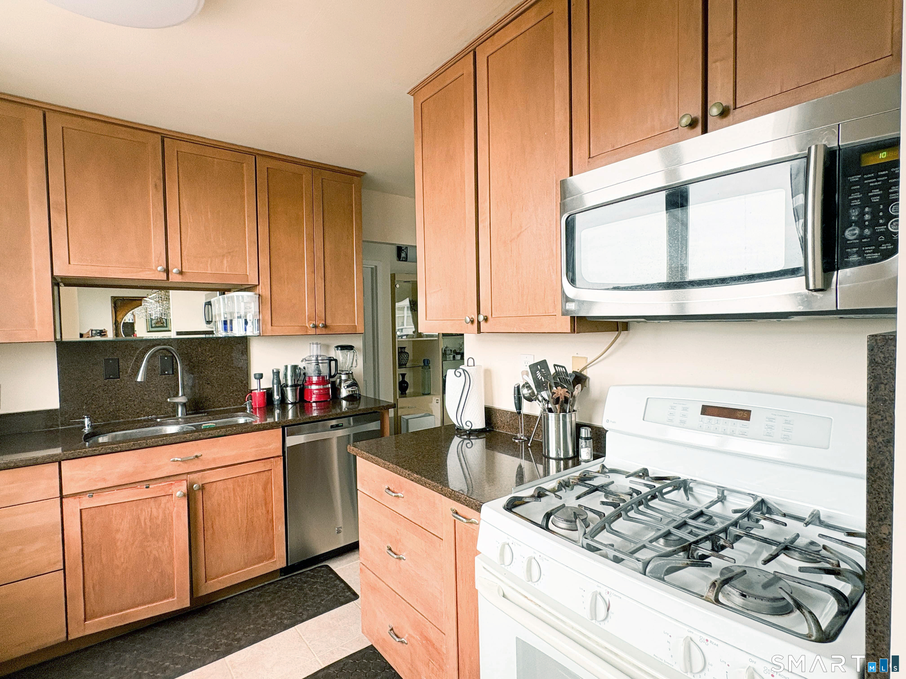 50 Glenbrook Road, Unit 9C Stamford, CT 06902 - Photo 4 of 20 a kitchen with stainless steel appliances granite countertop a sink stove and cabinets
