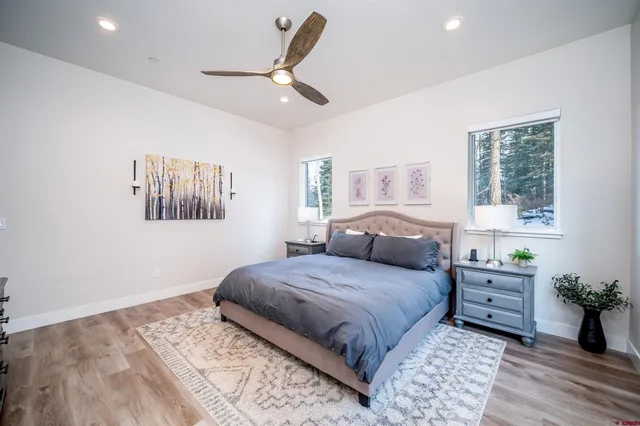 a bedroom with a large bed and a chandelier