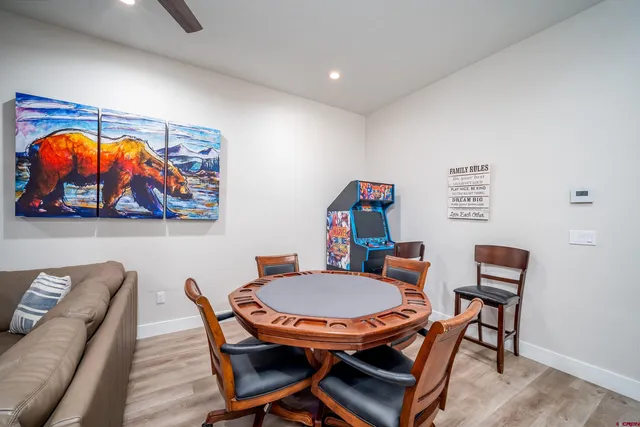 a dining room with furniture and wooden floor