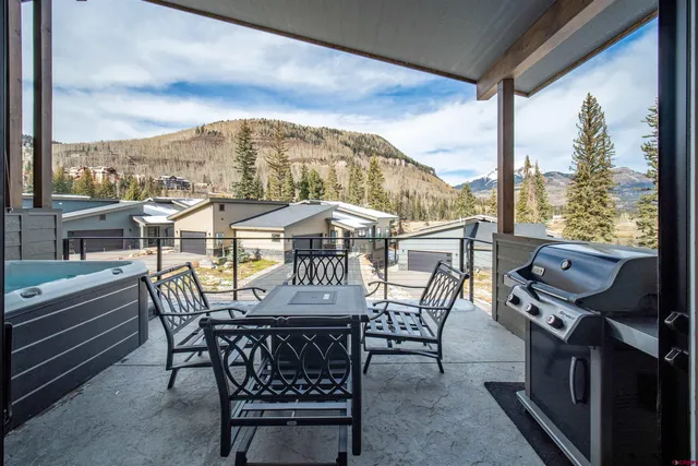 a view of city from balcony with furniture